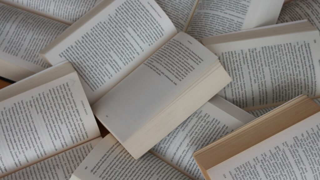 white and brown book on brown woven surface