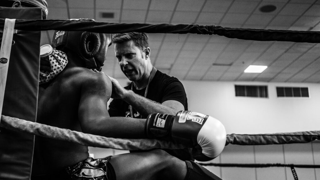 greyscale photography of a boxer inside reing